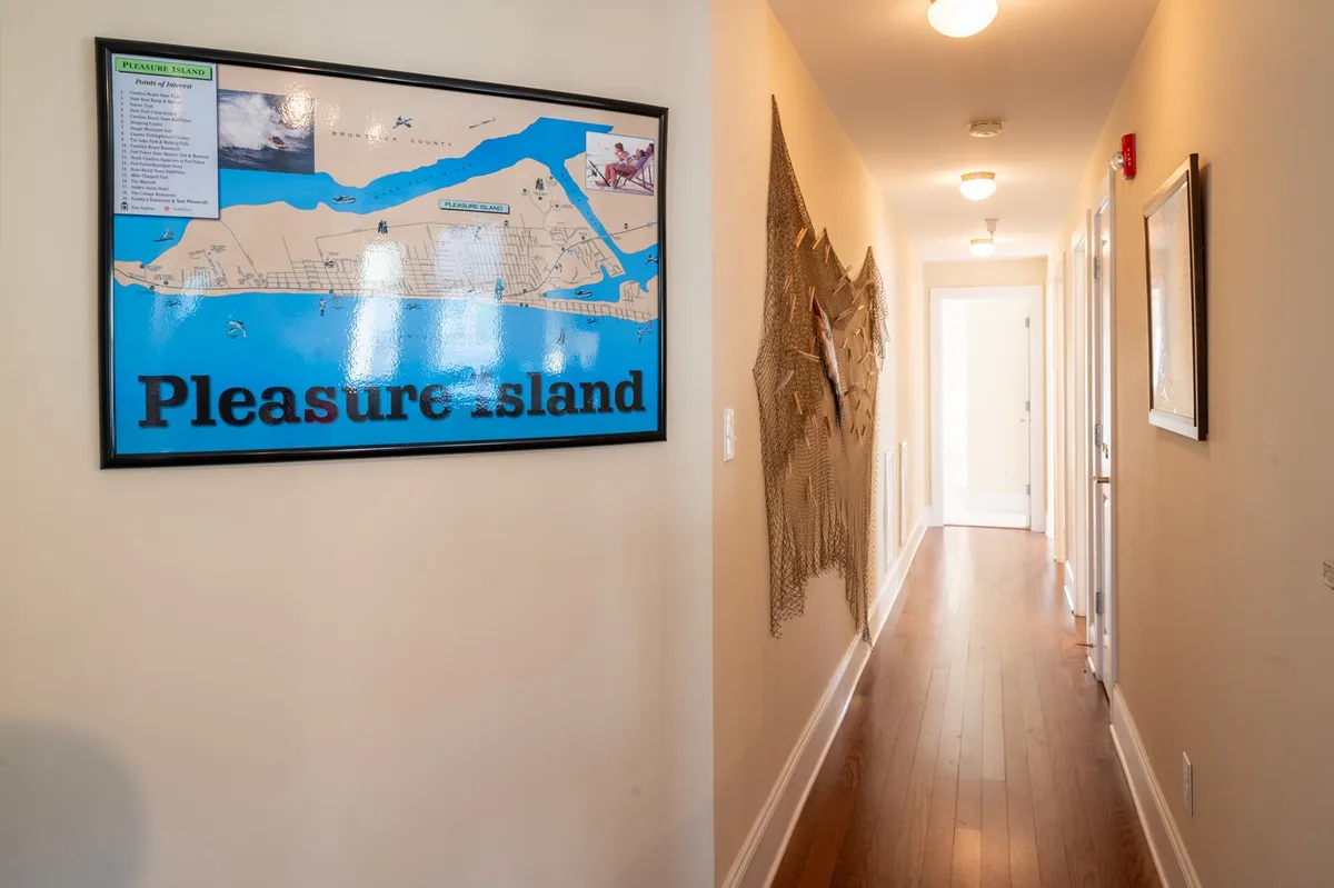 An inviting interior shot capturing a map of Pleasure Island and decorative wall art, perfect for planning outings or reminiscing about local adventures. The image hints at the broader local context and group experiences.